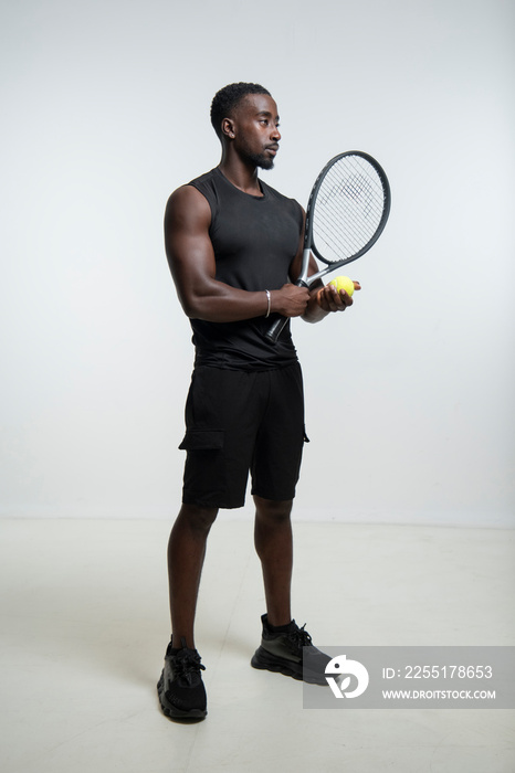 Man holding tennis ball and racket