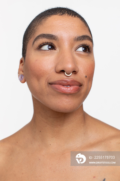 Studio portrait of woman with short hair and nose ring