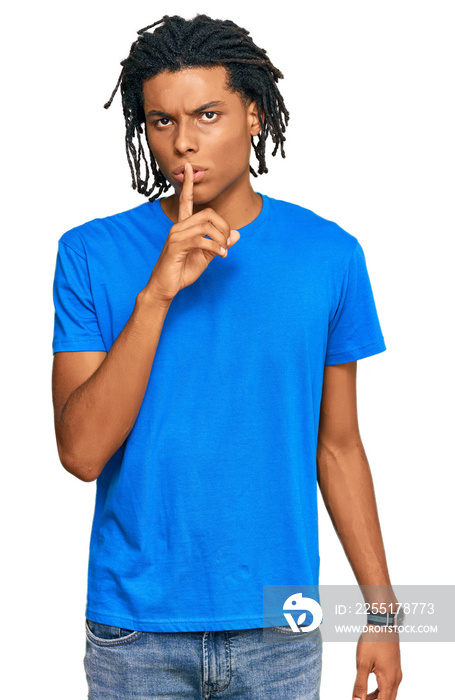 Young african american man wearing casual clothes asking to be quiet with finger on lips. silence and secret concept.