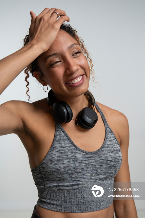 Smiling woman with headphones around neck