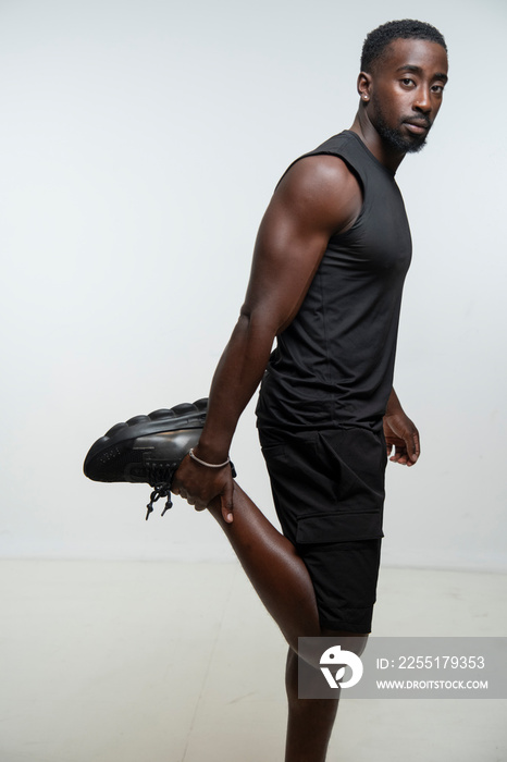 Athlete man stretching leg