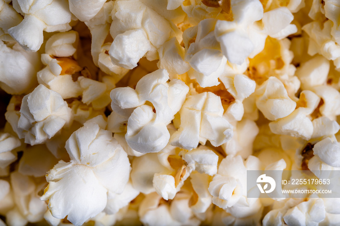 Extreme close-up overhead shot of several popcorns filling the frame, shot from above of many popcorns clustered together filling the entire image.