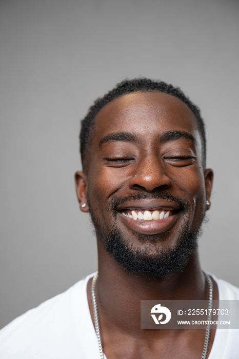 Portrait of smiling man with closed eyes