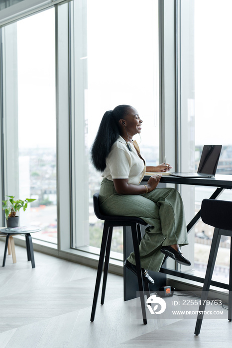 Businesswoman with laptop working in modern office