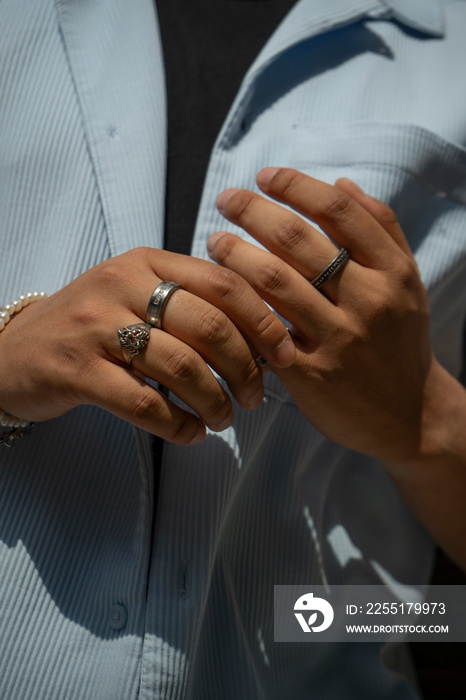 Man wearing bracelets and rings