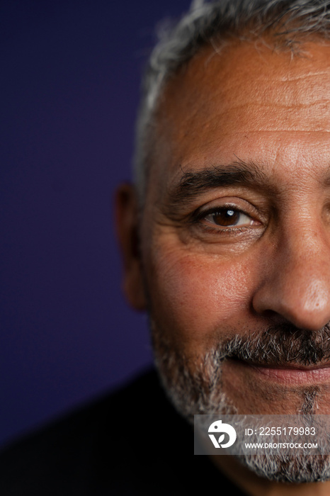 Portrait of smiling man against purple background