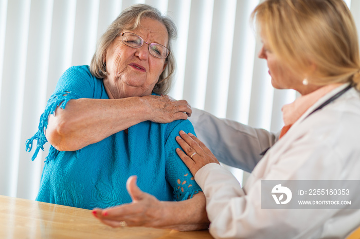 Senior Adult Woman Talking with Female Doctor About Sore Shoulder