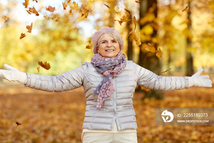 old age, retirement and season concept - happy senior woman enjoying beautiful autumn outdoors