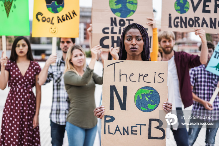 Young group of demonstrators on road from different culture and race protest for climate change - Focus on african woman