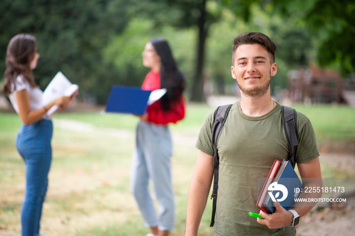 Young student in front of a group of friends