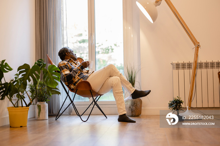 retired mature man enjoying a hot drink at home