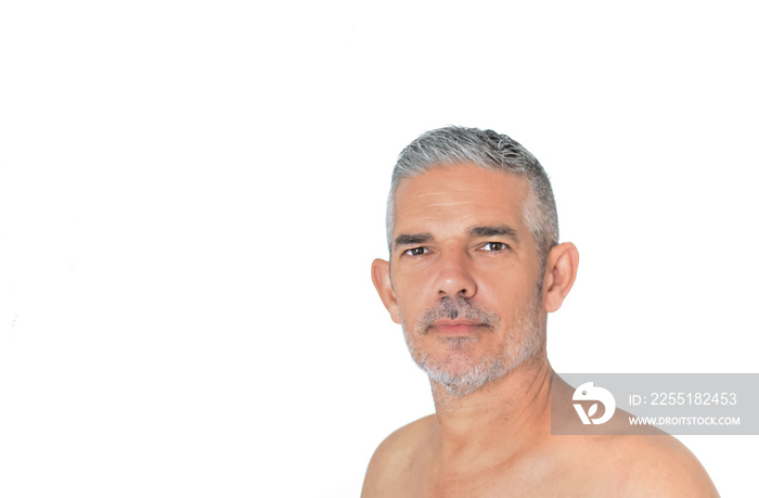 Portrait of mature attractive shirtless man with grey hair and unshaved against white background. Spa, wellbeing, healthy and seniors concept.