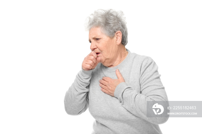 Portrait of coughing elderly woman on white background