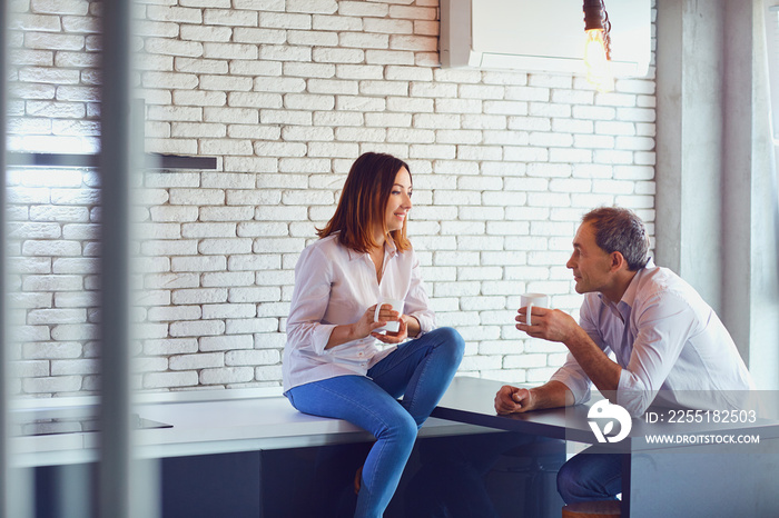 Mature couple with cup of coffee  indoors.