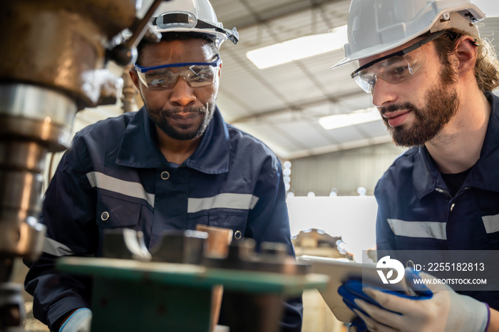 Team of engineers practicing maintenance Taking care and practicing maintenance of old machines in the factory so that they can be used continuously.