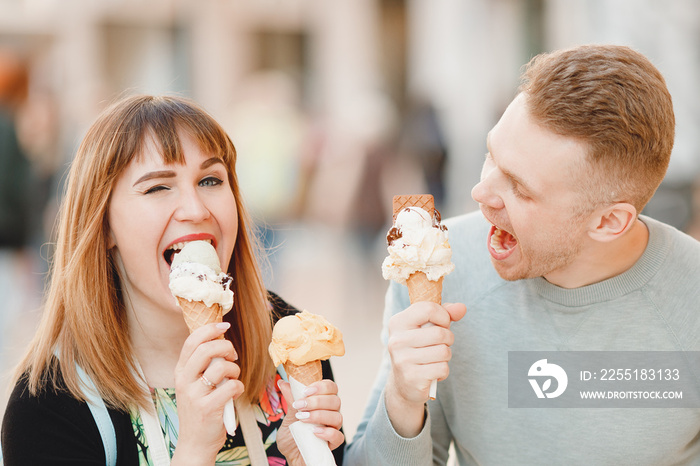 Cheerful couple man and girl friends in Rome eating Italy ice cream cones