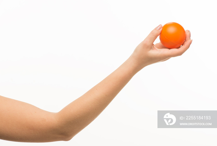 hand holding orange sponge ball isolated
