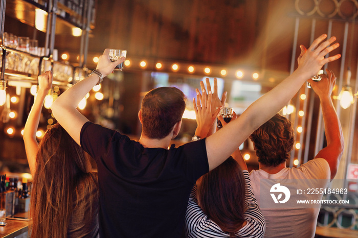 Group of friends watching soccer in pub