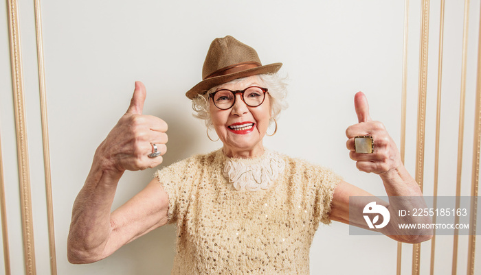 Cheerful old lady showing okay sign