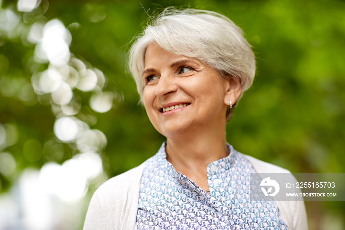 old age, retirement and people concept - portrait of happy senior woman at summer park