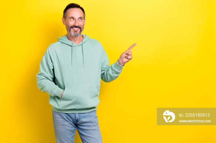 Photo of mature age businessman wear pastel green jumper finger point empty space useful tips look recommendation isolated on yellow color background