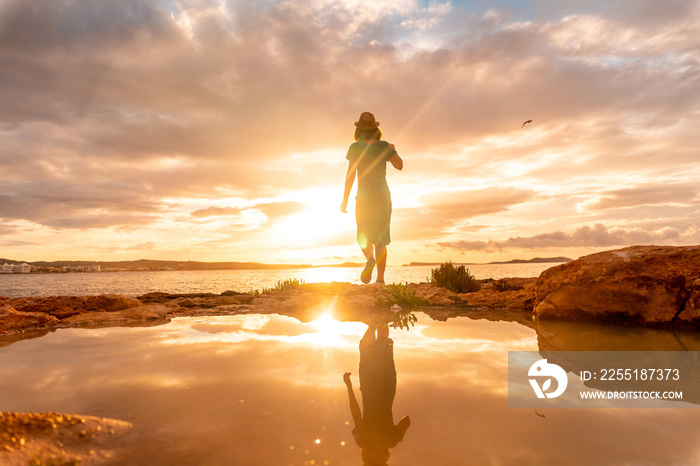 Sunset in Ibiza, a young tourist enjoying in San Antonio Abad. Balearic