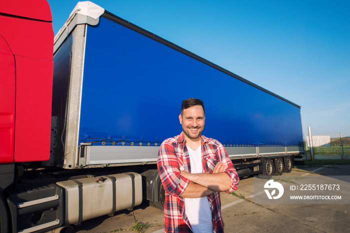 Truck driver occupation. Portrait of middle aged caucasian trucker with arms crossed standing by truck trailer ready for driving. transportation service.