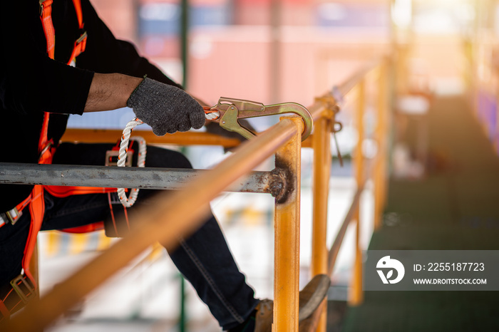 Construction worker wearing safety harness and safety line