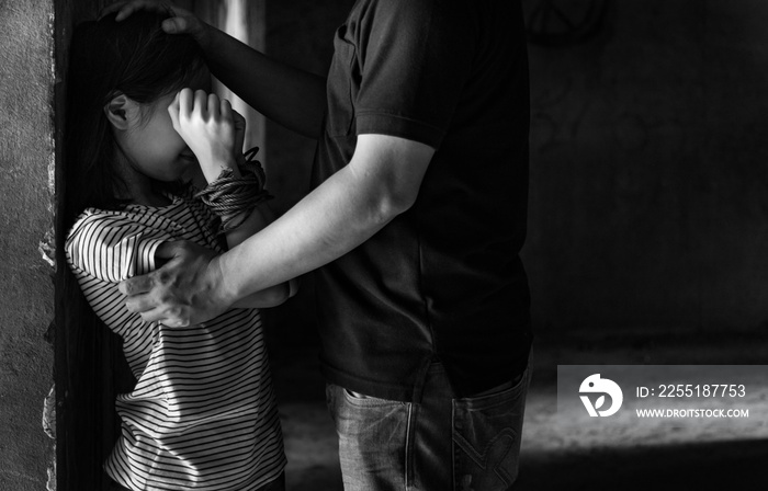 Asian girl with his hands tied in an abandoned building,stop abusing violence,human trafficking concept