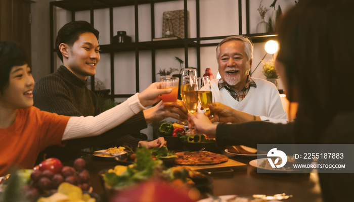 Asian family having dinner at dining table at home