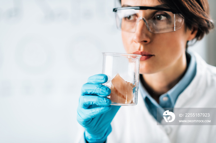 Sensory Analysis of Sea Fish Sample in a Test Tube. Food Safety Inspector Smelling Sample in Laboratory