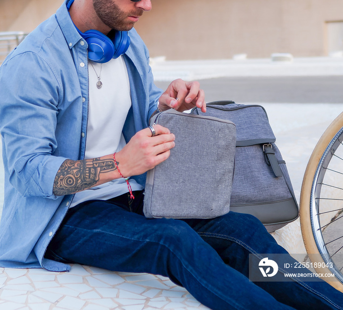 Young caucasian man closing laptop sleeve.