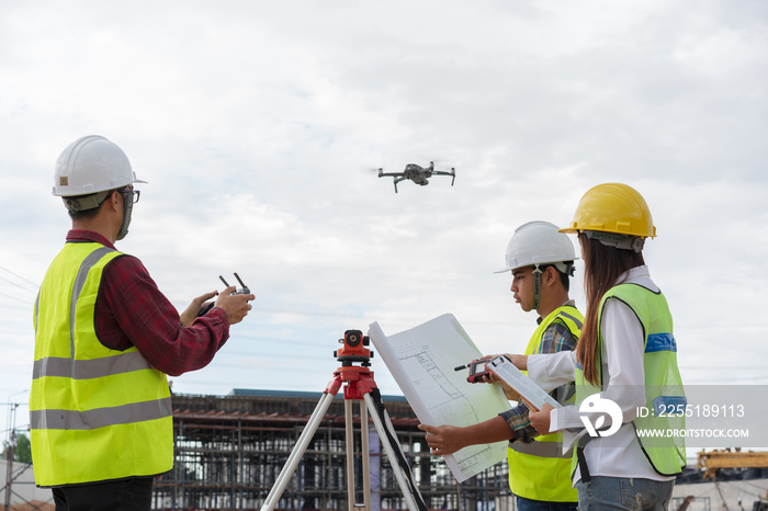 Construction concept , Engineer and Architect working with drone for inspection over construction site.