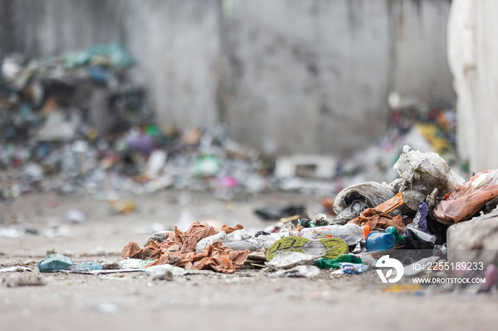 Landfill site, a pile of stinky different junk disposal in the concrete section for unsorted waste materials