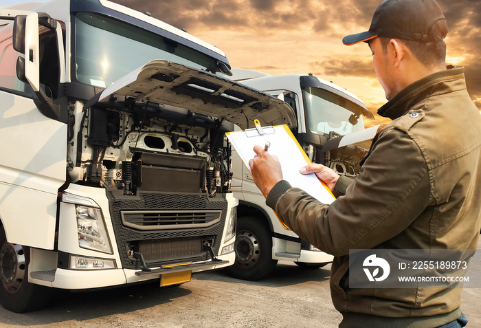 Portrait of truck driver inspecting safety checklist of a truck engine