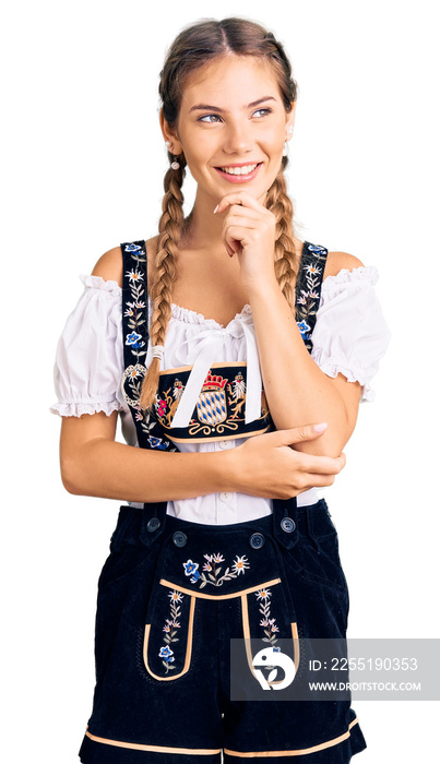 Beautiful caucasian woman with blonde hair wearing octoberfest traditional clothes with hand on chin thinking about question, pensive expression. smiling with thoughtful face. doubt concept.