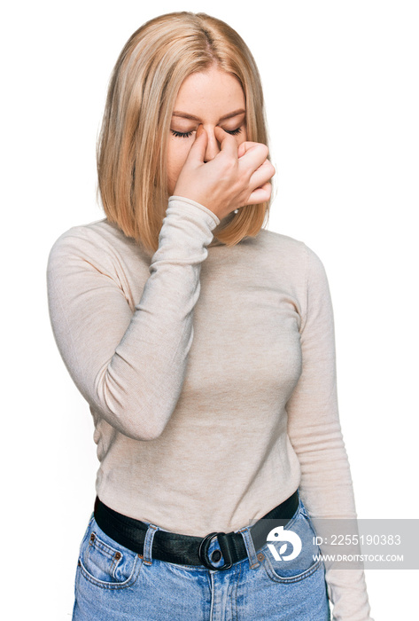 Young blonde woman wearing casual clothes tired rubbing nose and eyes feeling fatigue and headache. stress and frustration concept.