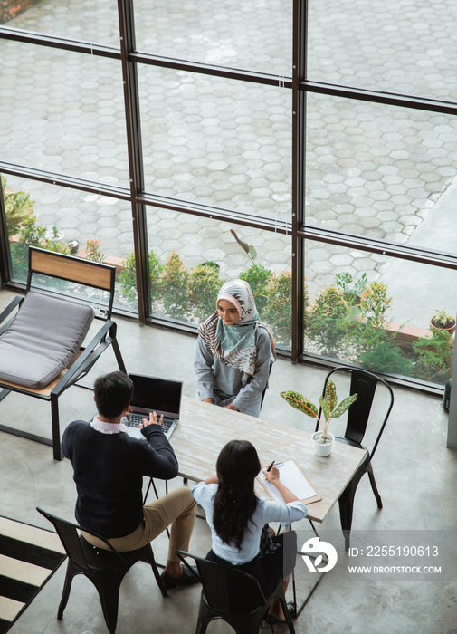 top view of woman with hijab applying a job on office recruitment day