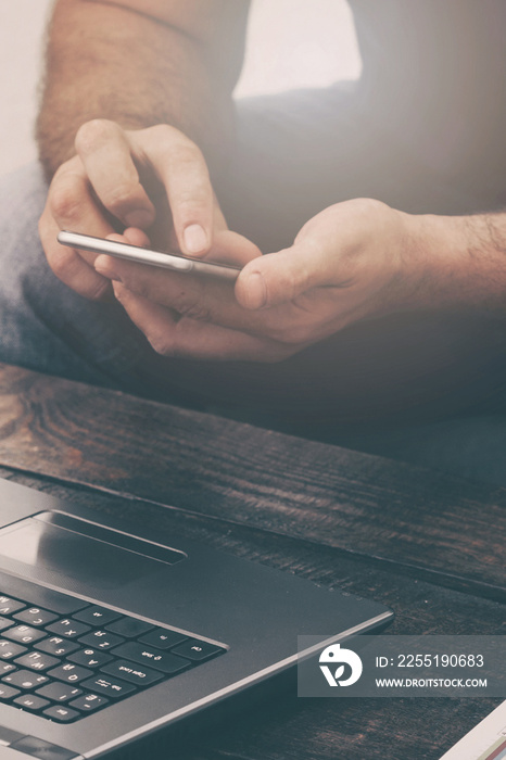 Businessman working laptop and smartphone on the sofa at home