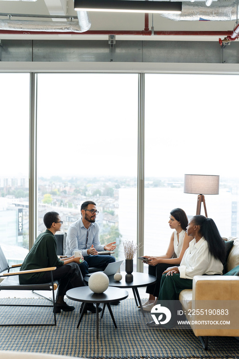 Business people having meeting in office lobby