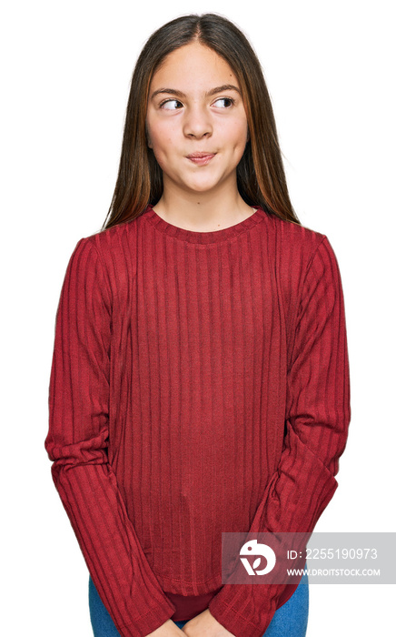 Beautiful brunette little girl wearing casual sweater smiling looking to the side and staring away thinking.