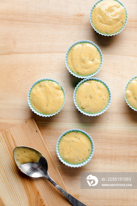 silicone bakeware filled muffin batter on wooden background