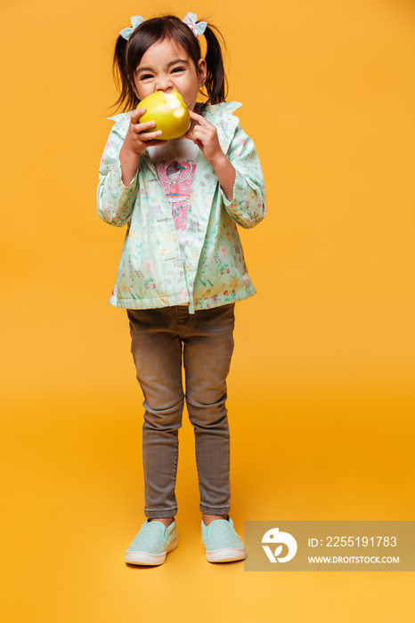 Cute little girl child eating apple.