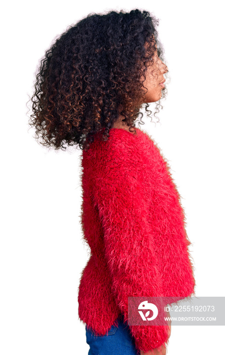 African american child with curly hair wearing casual winter sweater looking to side, relax profile pose with natural face with confident smile.