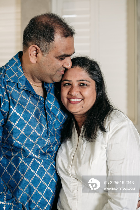 South Asian couple cooking in the Kitchen