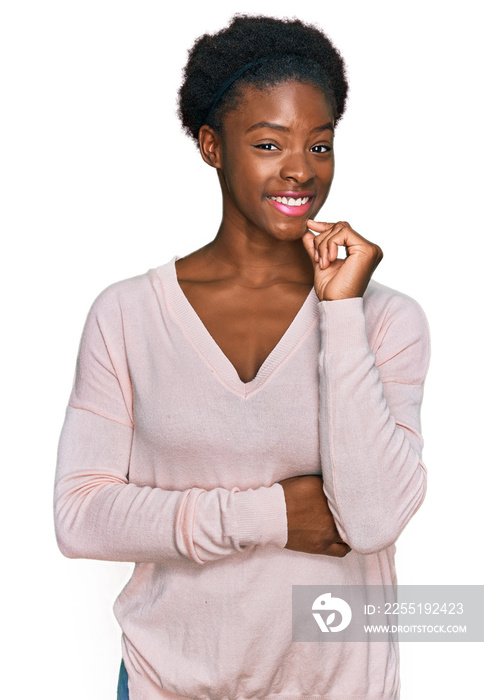 Young african american girl wearing casual clothes looking confident at the camera smiling with crossed arms and hand raised on chin. thinking positive.