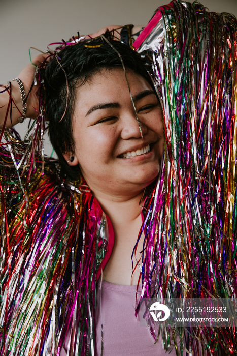 close up portrait of plus size filipino woman smiling eyes closed