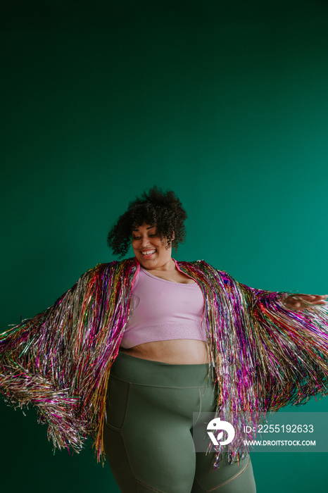 plus size person dancing with rainbow jacket