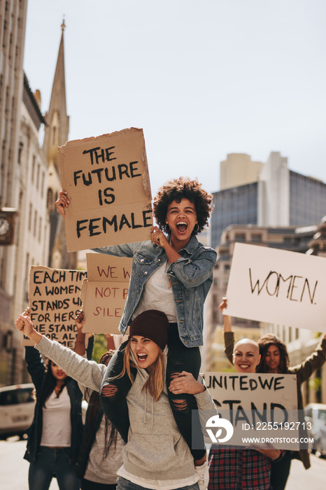 Women enjoying during a demonstration on road