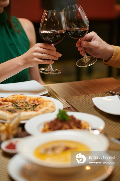 Couple enjoying romantic date in restaurant and drinking red wine